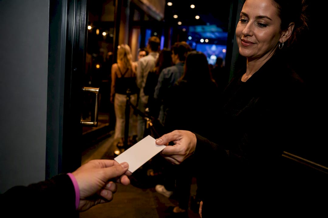 Usher checking fan ticket at live taping